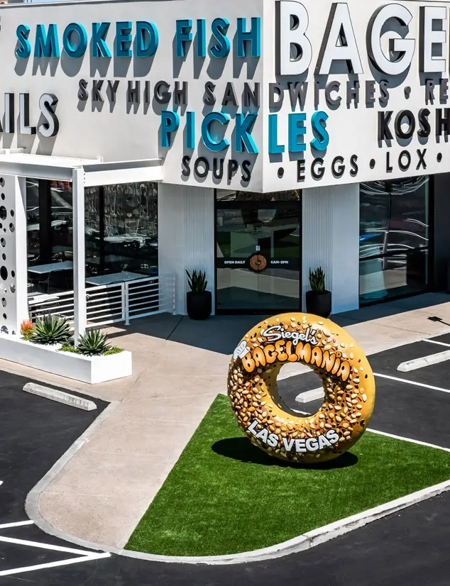 Bagelmania exterior with bagel statue